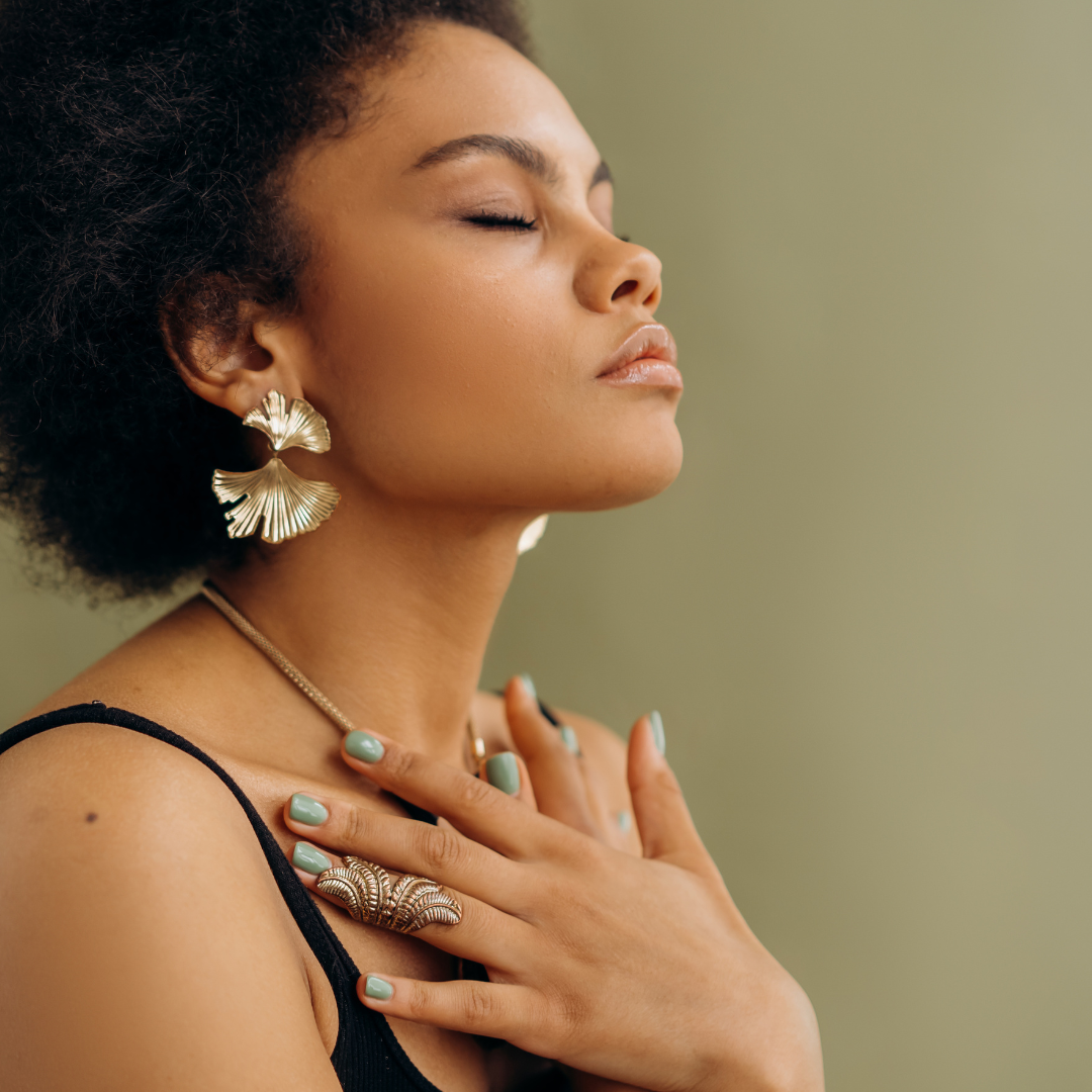 woman-eyes-closed-with-hands-on-chest-grounding-herself