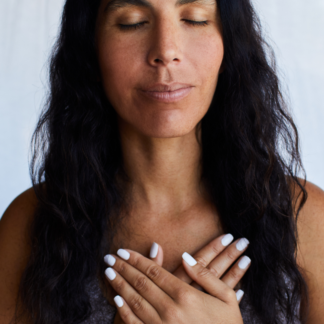 woman-front-facing-with-eyes-closed-hands-on-chest