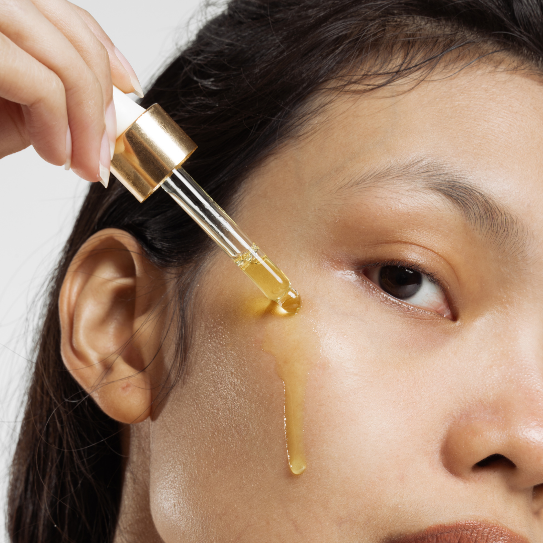 woman-applying-oil-to-face-with-dropper